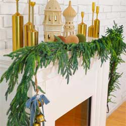 norfolk pine garland on fireplace mantel